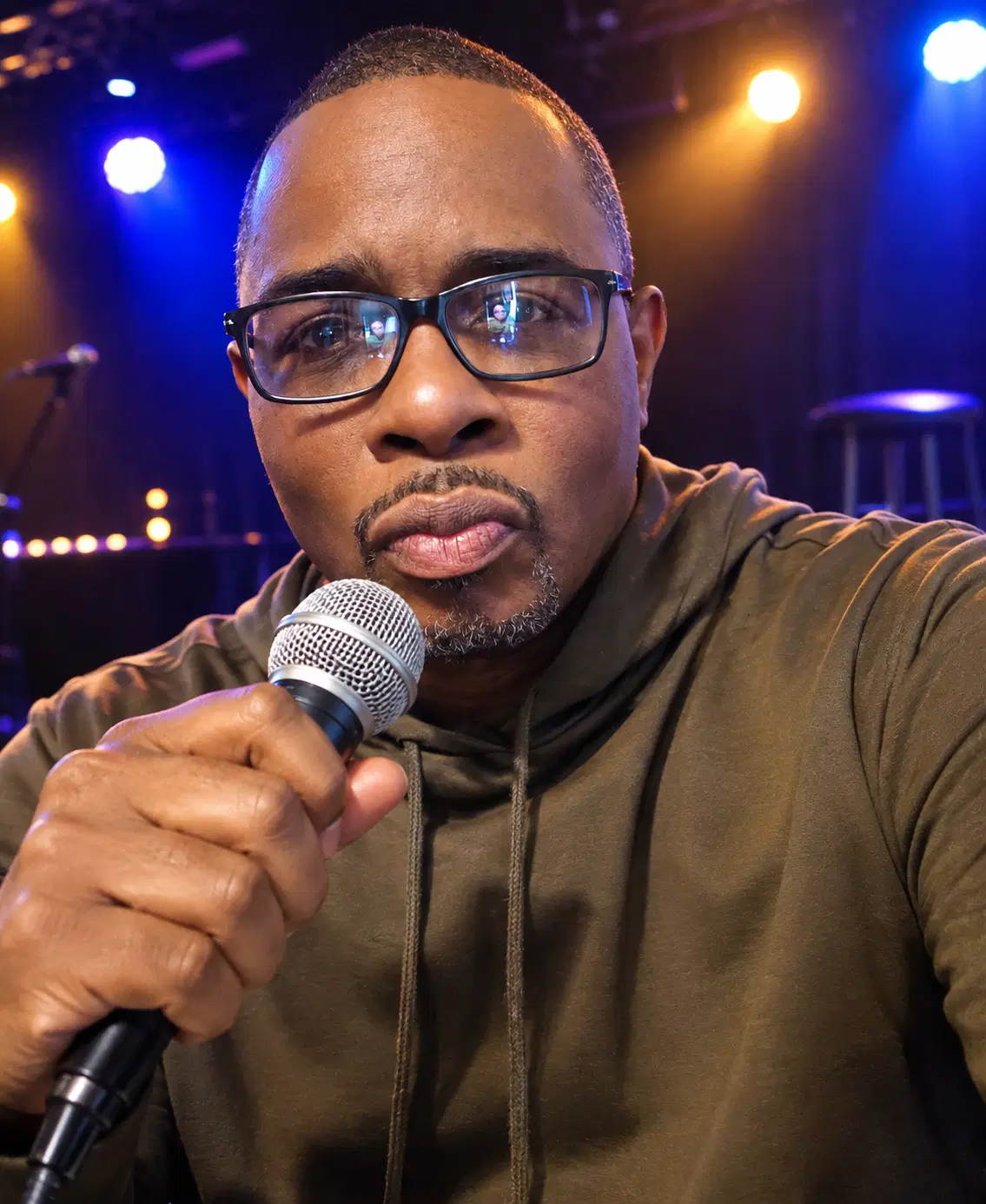 Shawn Cornelius close-up on stage with the crowd behind him
